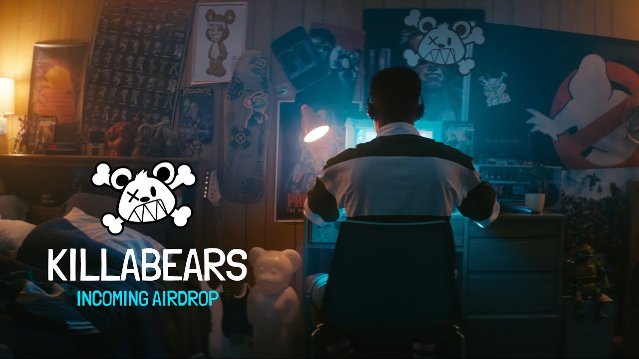 A man at his computer in a room filled with Killabears artwork
